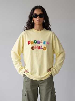 AI fashion model in sunglasses wearing a yellow Problem Child sweatshirt and cargo pants